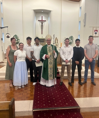 Jack McMillan standing next to Bishop Stuart Hall along with other ADF cadets inside the RMC Chapel at  Duntroon ACT